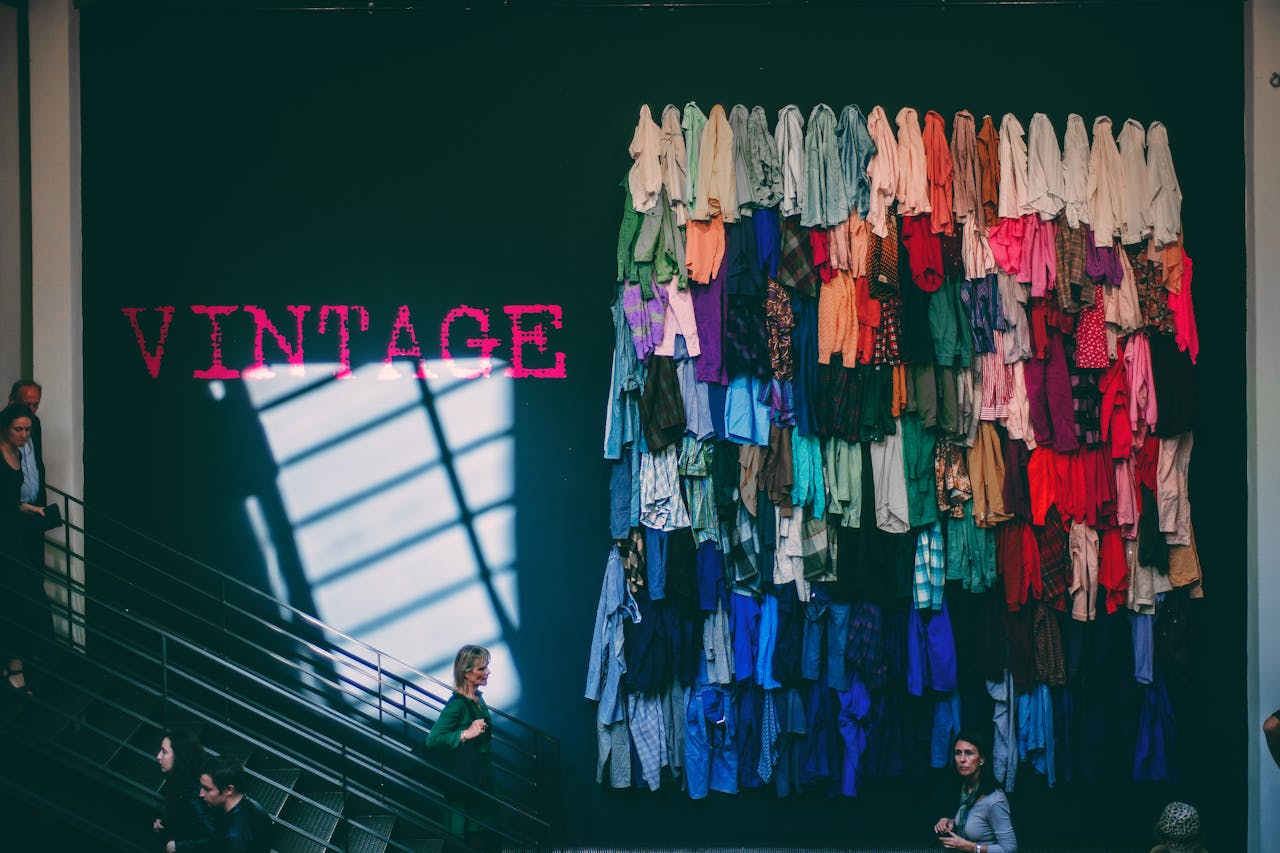 gallery-1 A vibrant display of assorted vintage clothes on a showroom wall inside a retail store.